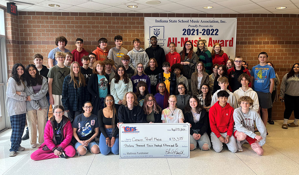 Class from the Indiana State School Music Associate all posing while holding a cheque from the mattress fundraiser